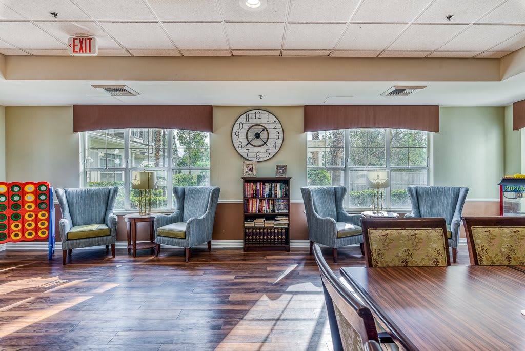 A cozy lobby with comfortable seating and a large clock on the wall.