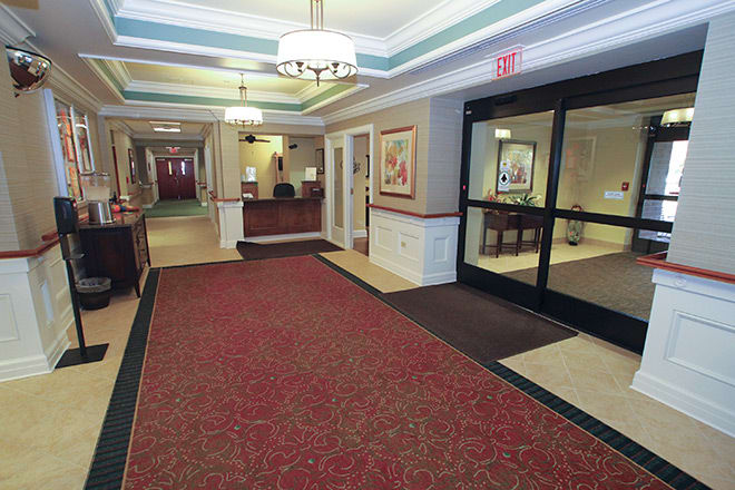 A welcoming lobby area with a reception desk and red carpet.