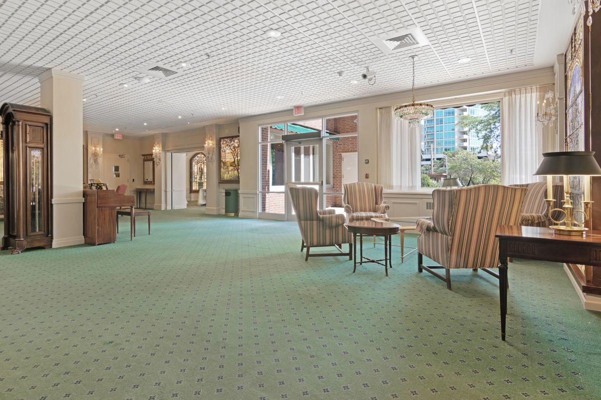 A spacious lobby area featuring comfortable seating and large windows allowing natural light.
