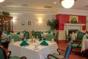 A cozy dining room with neatly set tables and elegant decor.