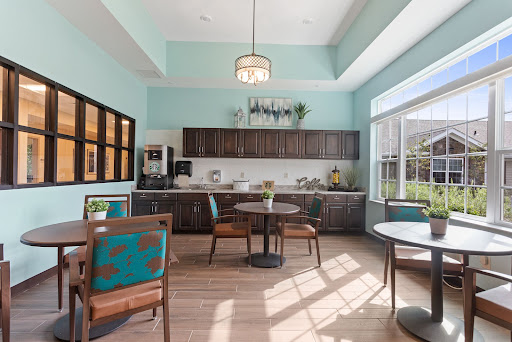 A modern kitchen and dining area featuring a bright color scheme and ample natural light.