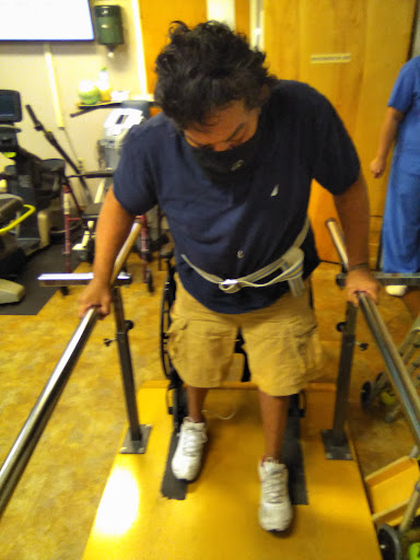 A patient using a walking aid during physical therapy.