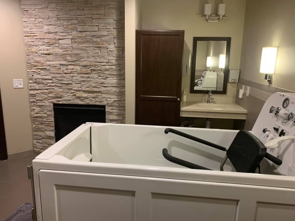 A modern bathroom featuring a bathtub, sink, and mirror with stylish design elements.