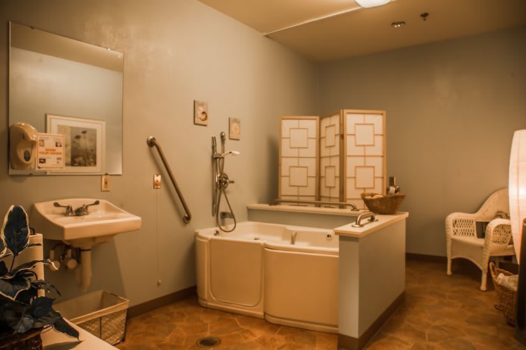 A cozy bathroom with a large bathtub and stylish decor.