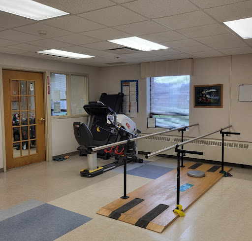 A well-equipped rehabilitation room featuring various therapy and exercise equipment.