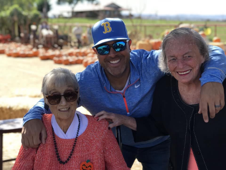 A group of three people enjoying a sunny day outdoors together.