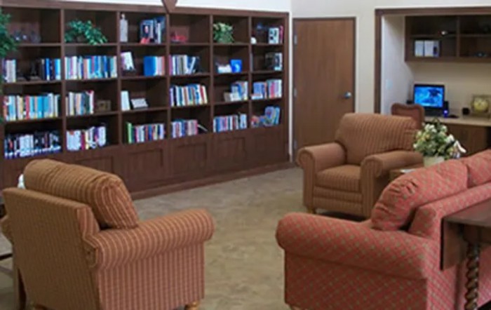 A cozy reading area with bookshelves and comfortable armchairs.