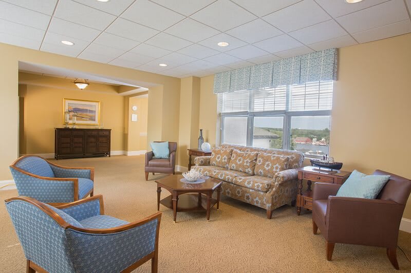 A cozy living room with comfortable seating and a scenic window view.