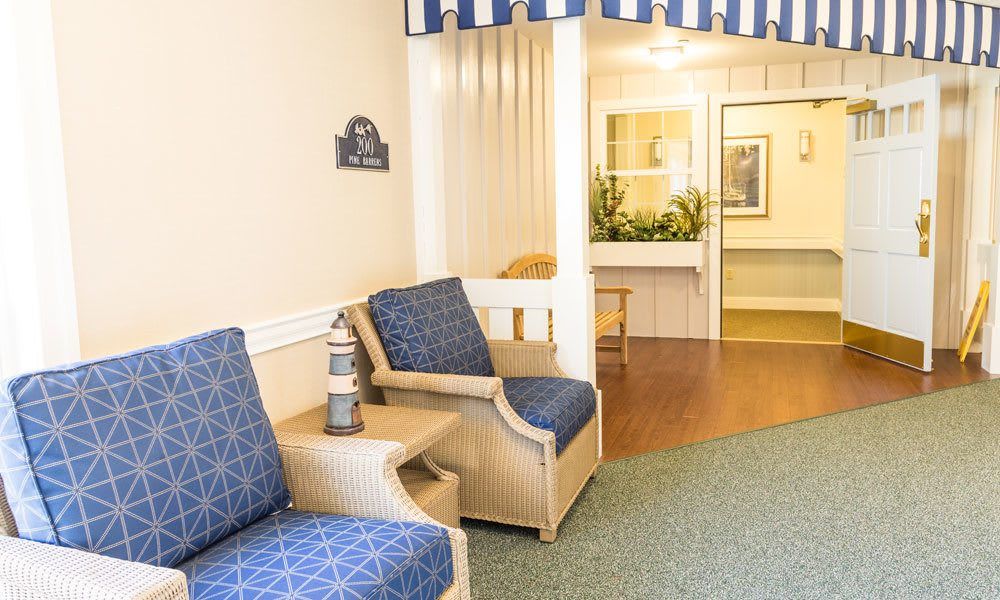A cozy waiting area with blue upholstered chairs and decorative elements.