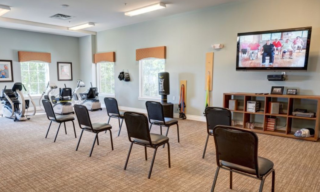 A well-organized meeting room with several chairs arranged in rows, ready for a seminar or conference.