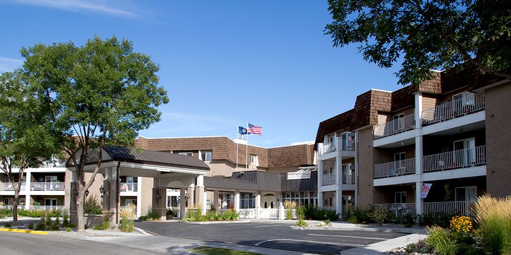 Exterior view of a healthcare facility with flags flying above.