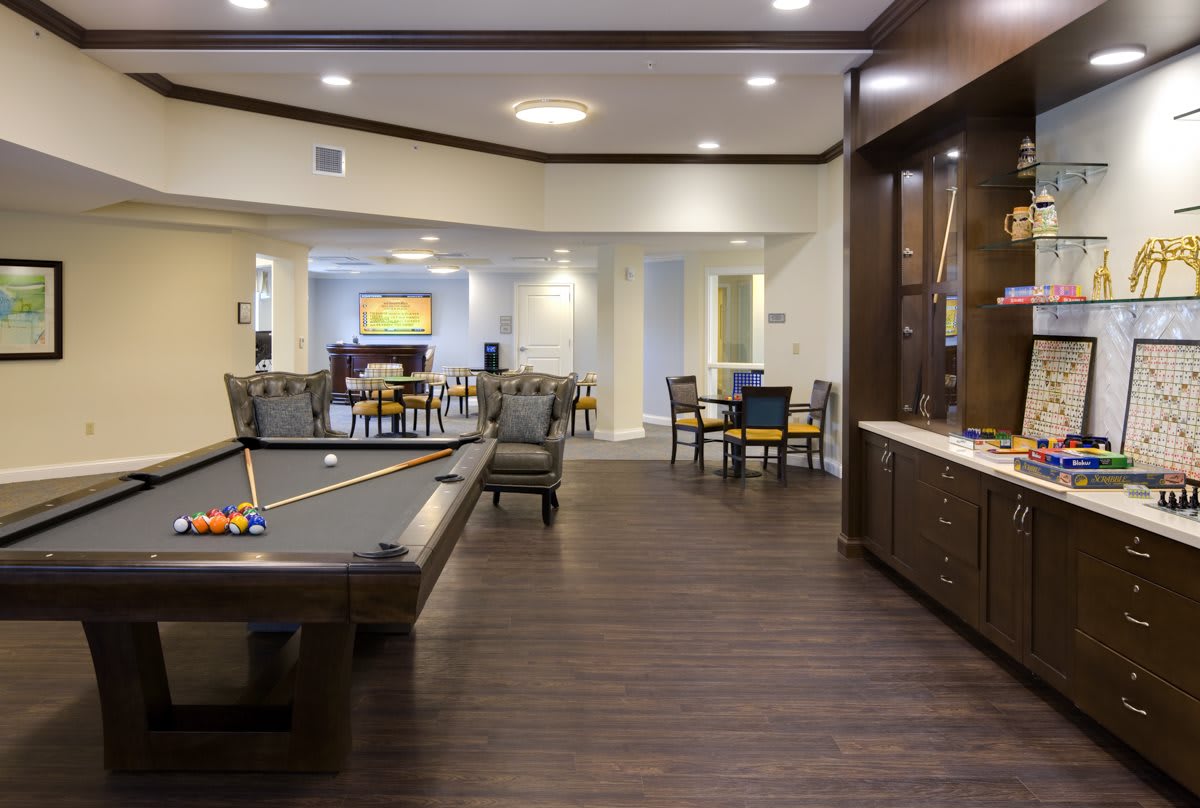 A stylish game room featuring a pool table and comfortable seating.