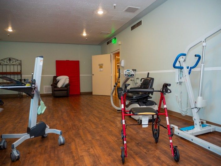 A physical therapy room equipped with various rehabilitation tools and exercise machines.