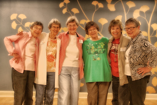 A joyful group of women posing together, celebrating friendship and camaraderie.