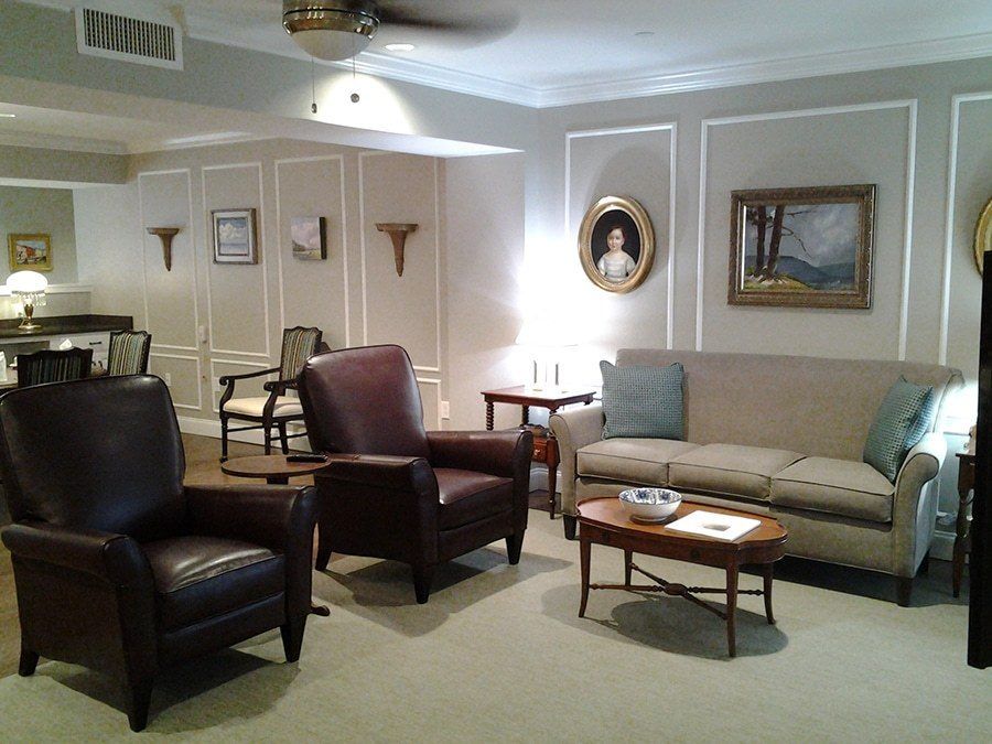 A cozy living room with armchairs, a sofa, and elegant decor.