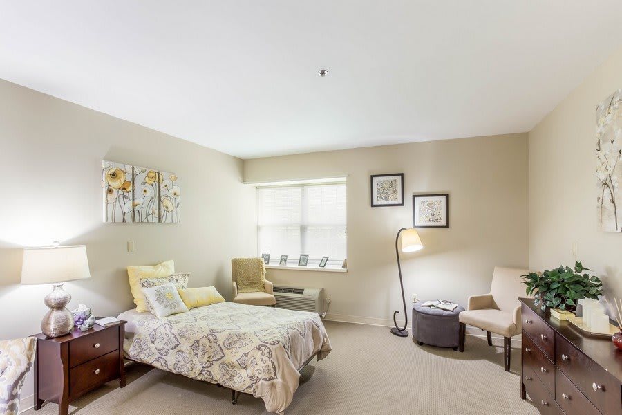 A cozy bedroom with simple decor and natural light.