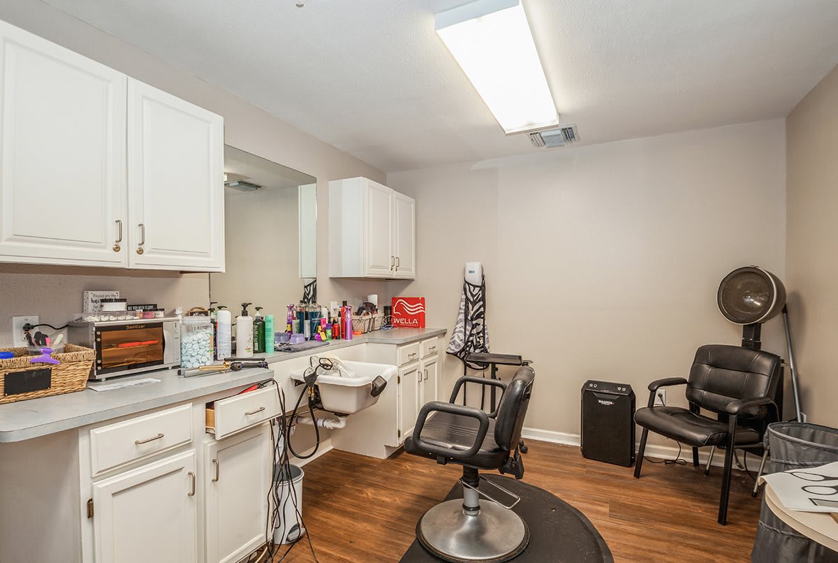 A well-equipped hair salon interior with styling chairs and beauty products.