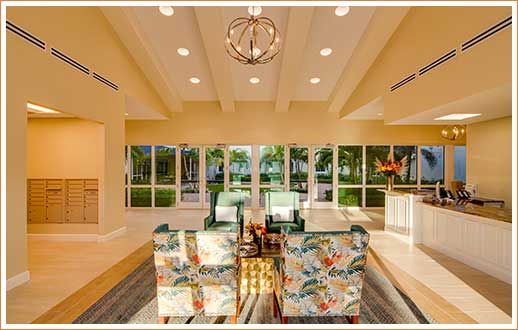 A spacious and well-lit living room with a contemporary dining area, featuring large windows and modern decor.