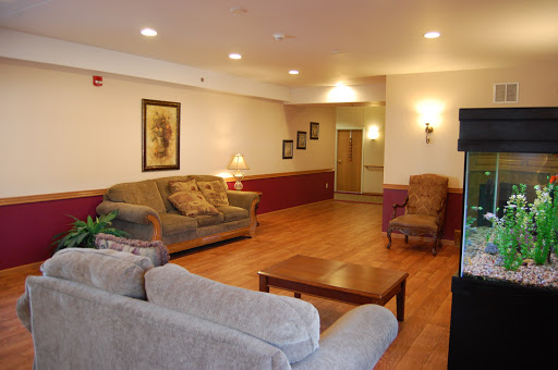 A spacious and inviting living room featuring comfortable seating and warm lighting.