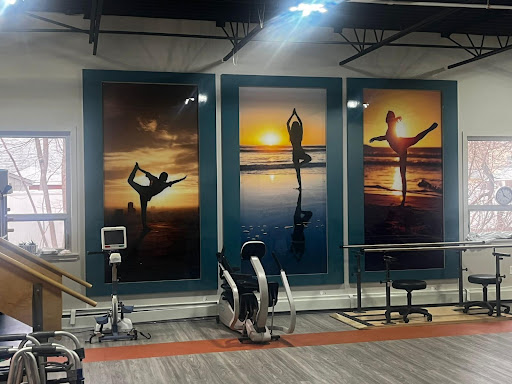 Inspiring gym decor featuring vibrant sunset silhouettes of yoga and dance.