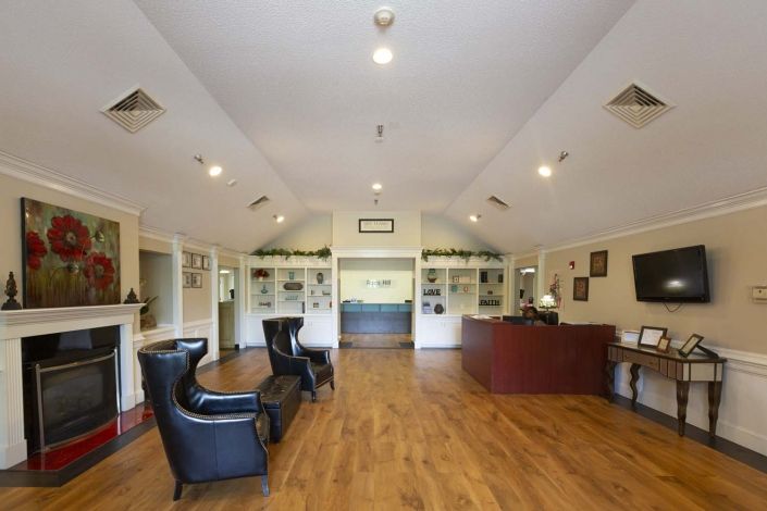A spacious lobby area with seating and a reception desk.