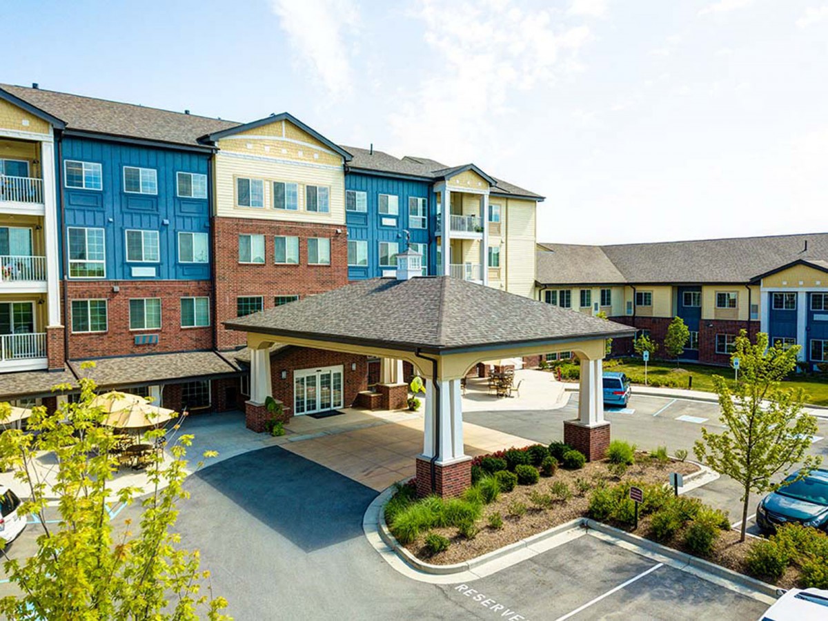 The exterior view of a modern hotel with a welcoming entrance and landscaped surroundings.