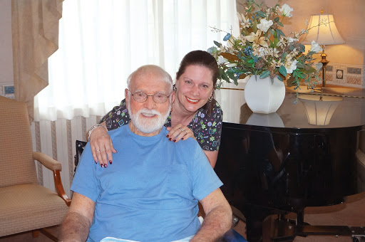 A joyful moment shared between an elderly man and a young woman, showcasing the warmth of family connections.