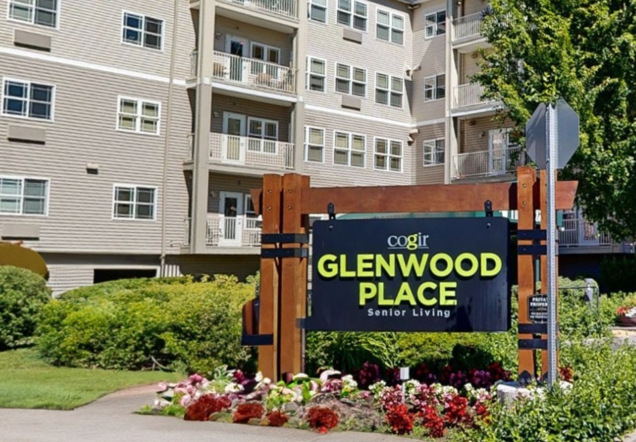 Entrance sign for Glenwood Place apartment complex with surrounding landscaping.