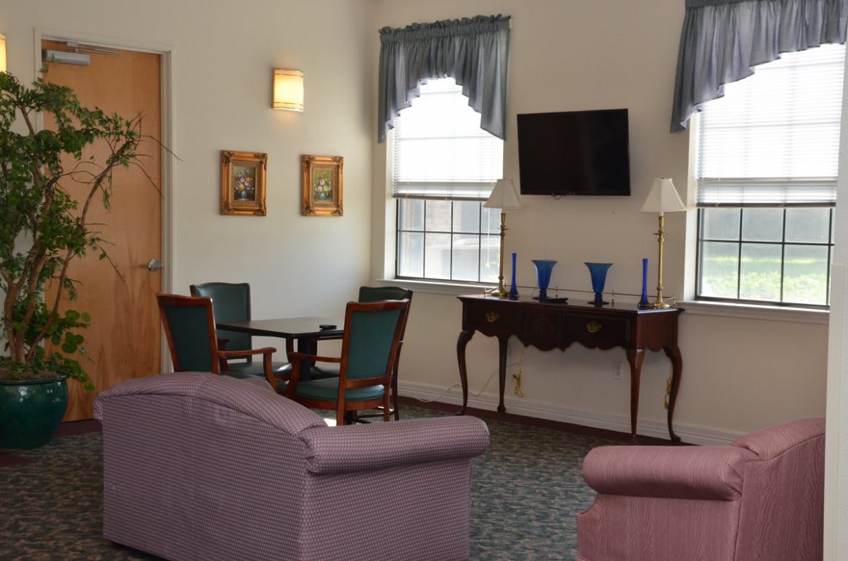 A cozy living room with comfortable seating, a television, and elegant decor.