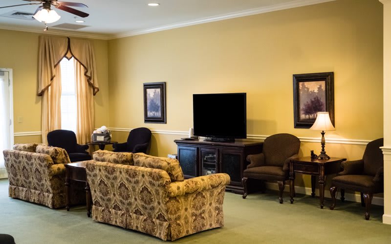 A cozy living room with comfortable seating, a television, and tasteful decor.