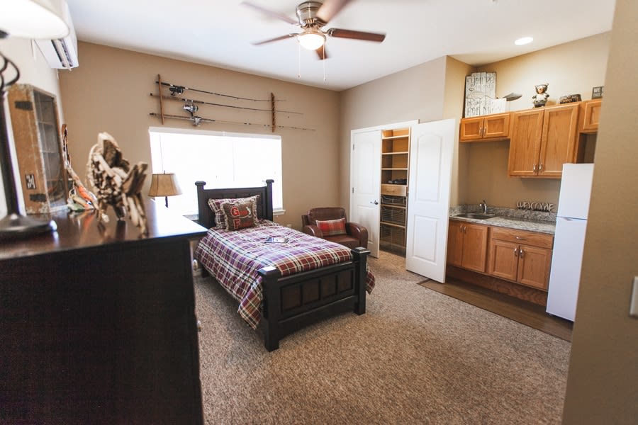 Cozy bedroom featuring a single bed with traditional decor and rustic elements.