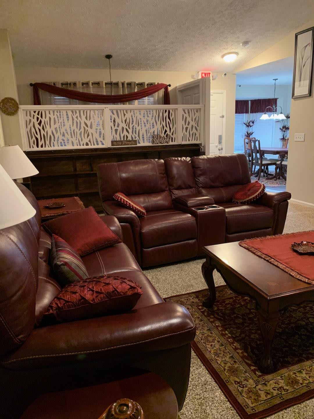A cozy living room with leather sofas and a coffee table.