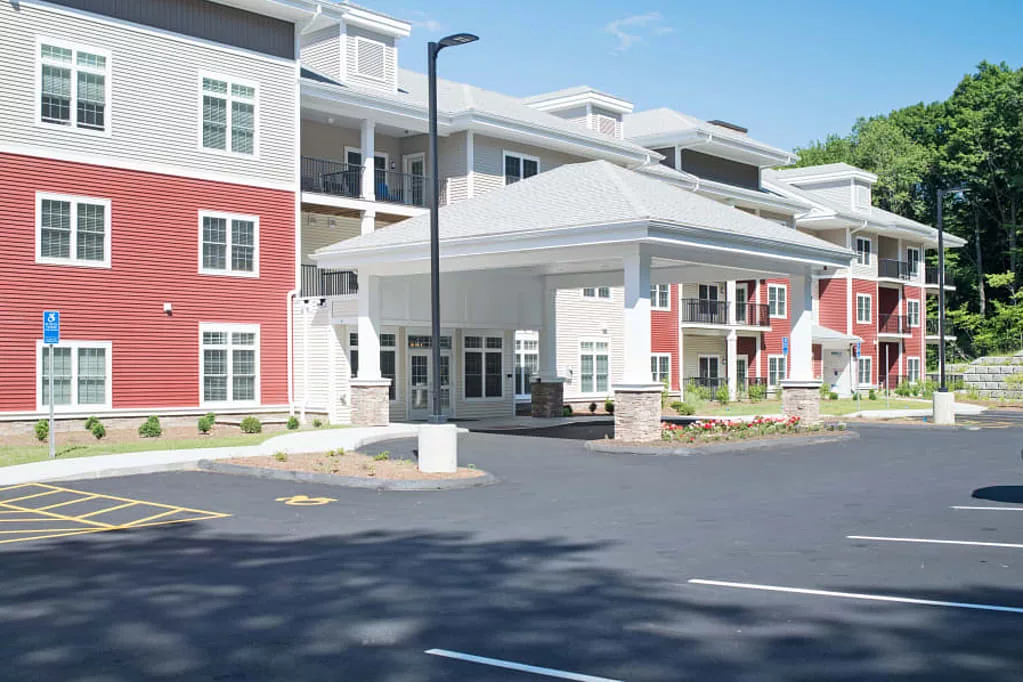 A modern residential apartment complex with a large entrance and multiple stories.