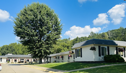A peaceful suburban scene featuring residential houses under a clear blue sky.