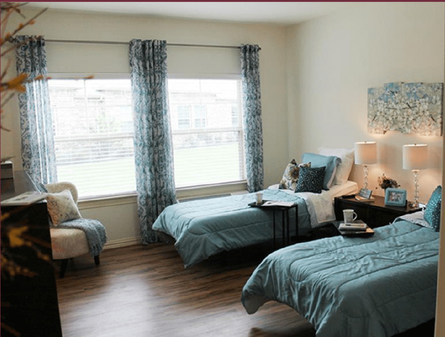 A modern bedroom with twin beds and stylish decor.