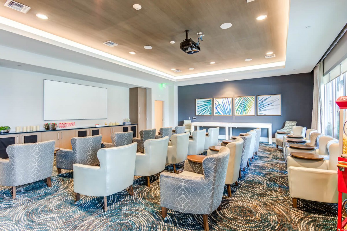 A modern conference room with comfortable seating and a projector.