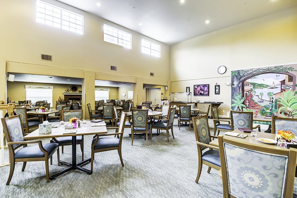 A spacious and bright dining room with neatly arranged tables and chairs.