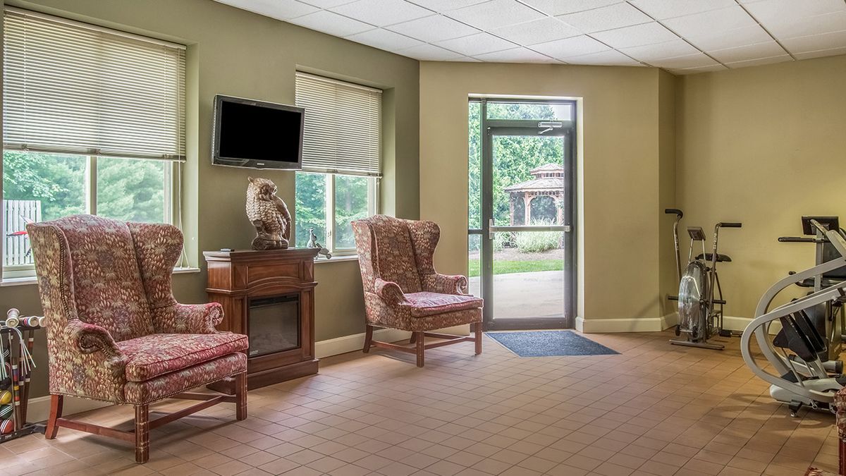 A cozy waiting room with chairs and a television.