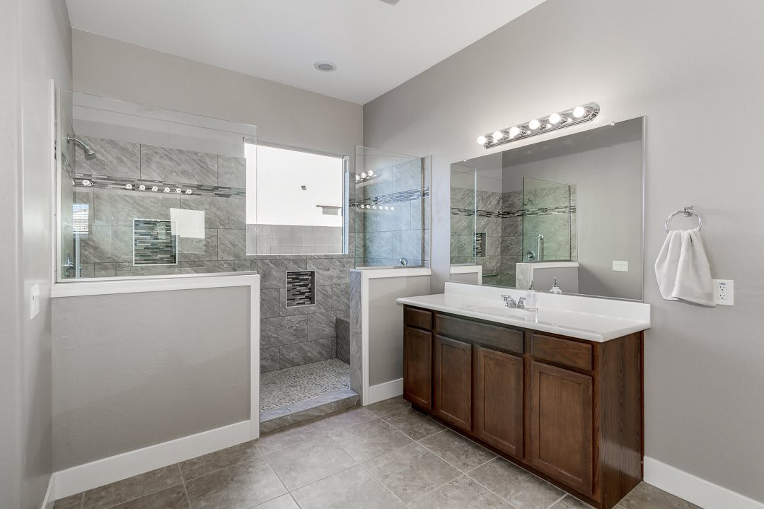 Modern bathroom with a glass-enclosed shower and spacious vanity.