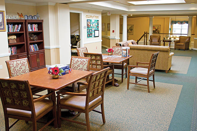 A communal dining area with neatly arranged tables and chairs.