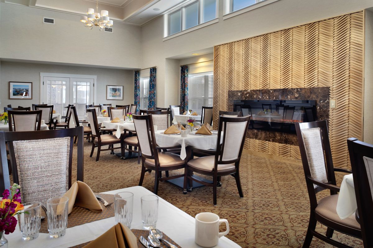 An elegant restaurant dining area with neatly arranged tables and chairs.