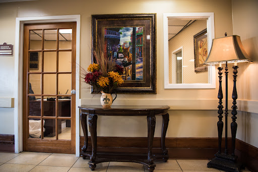 A beautifully decorated entryway featuring a dark wooden table, a floral arrangement, and artwork on the wall.