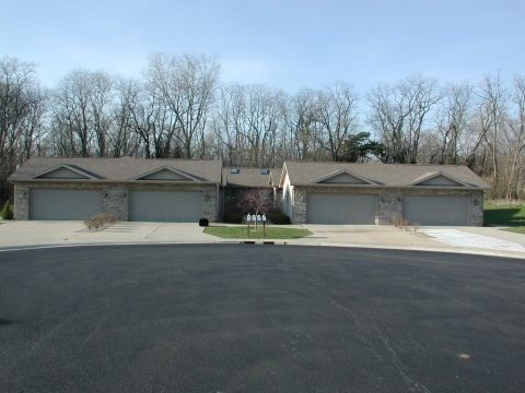 A row of houses with garages situated in a suburban cul-de-sac.