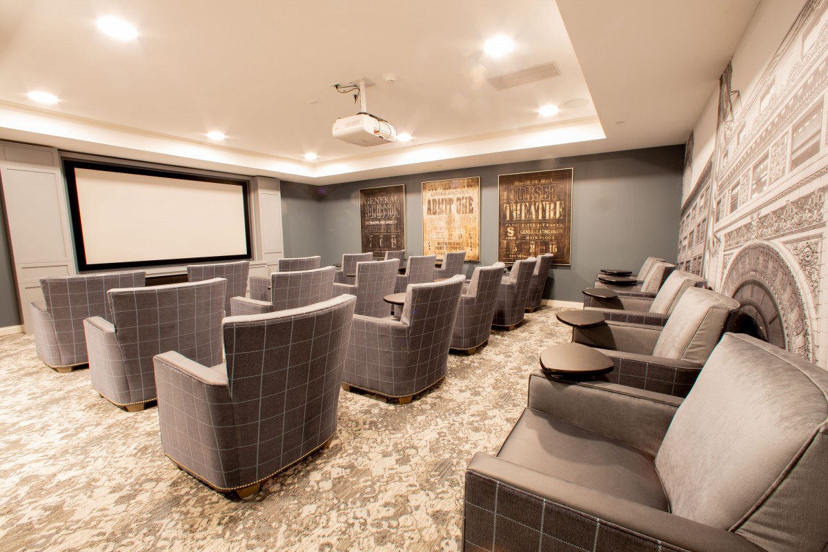 A modern home theater with comfortable seating and a large screen.