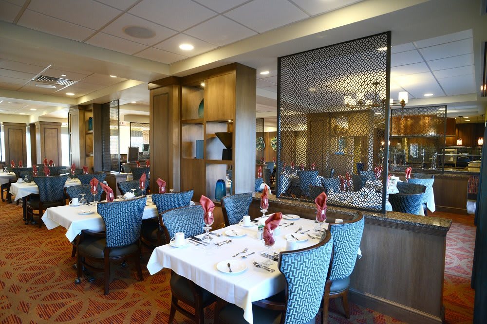 An elegant dining area with neatly set tables and cozy chairs in a restaurant.