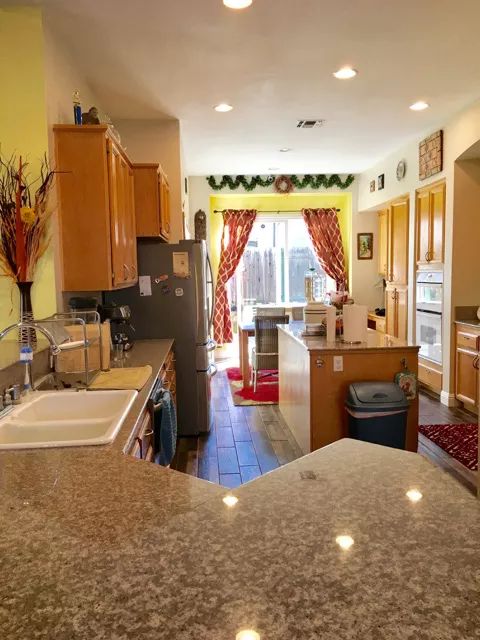 A spacious kitchen with modern appliances, featuring an island and ample countertop space.