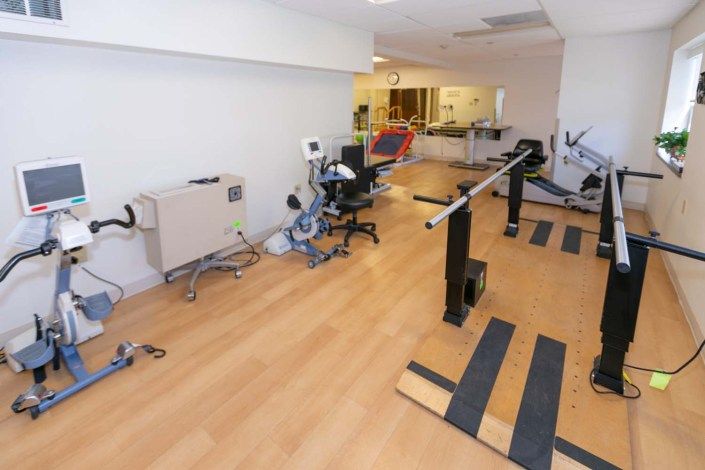 A physical therapy clinic with exercise equipment for rehabilitation.