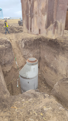 An underground tank is revealed during excavation work.