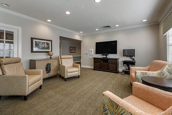 A cozy living room with comfortable seating and a large television.
