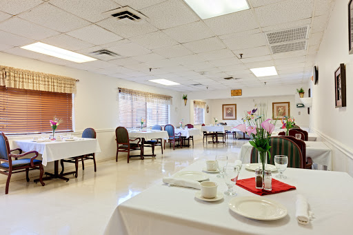 A spacious and elegantly arranged dining room setting, ready for guests.
